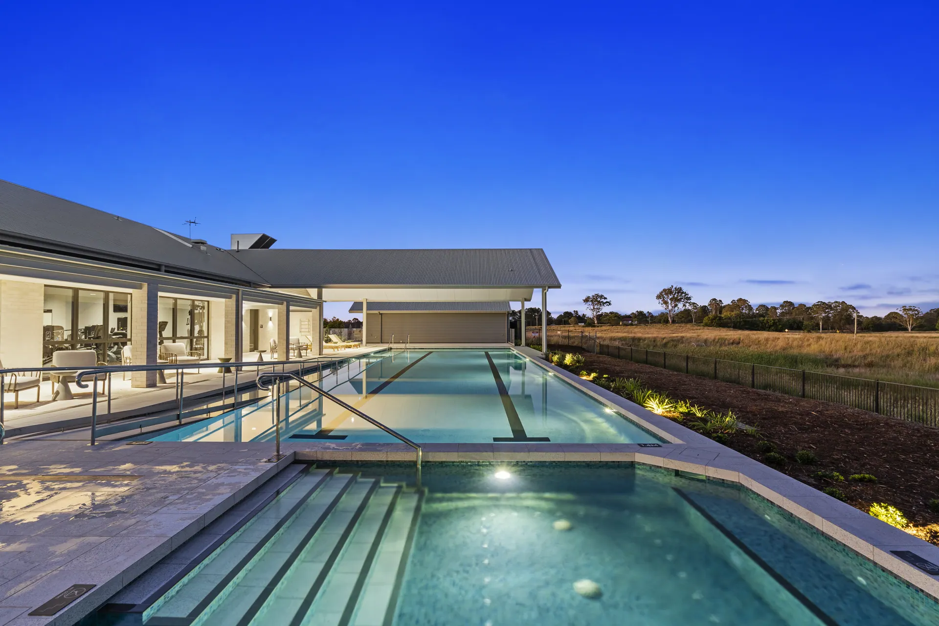 Resort-style pool and covered terrace at an aged care community at dusk