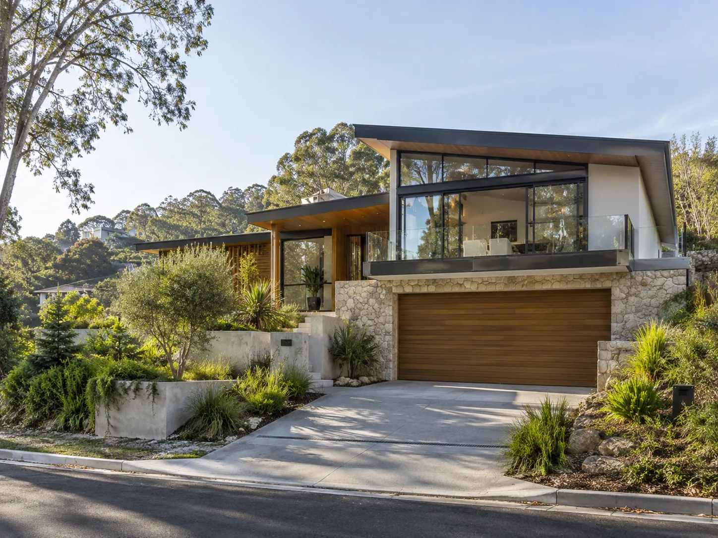 Hillside home with stone cladding and landscaped driveway