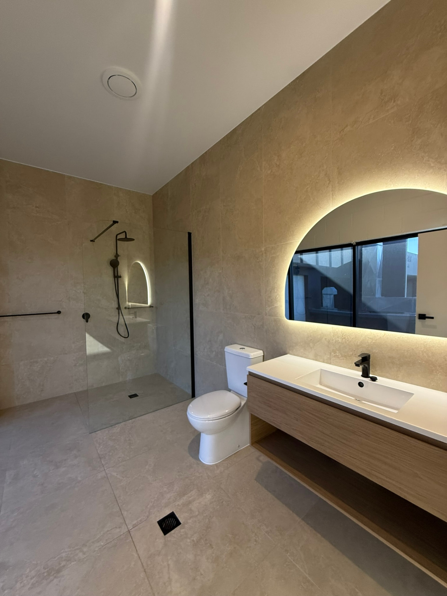 Accessible bathroom with backlit mirror