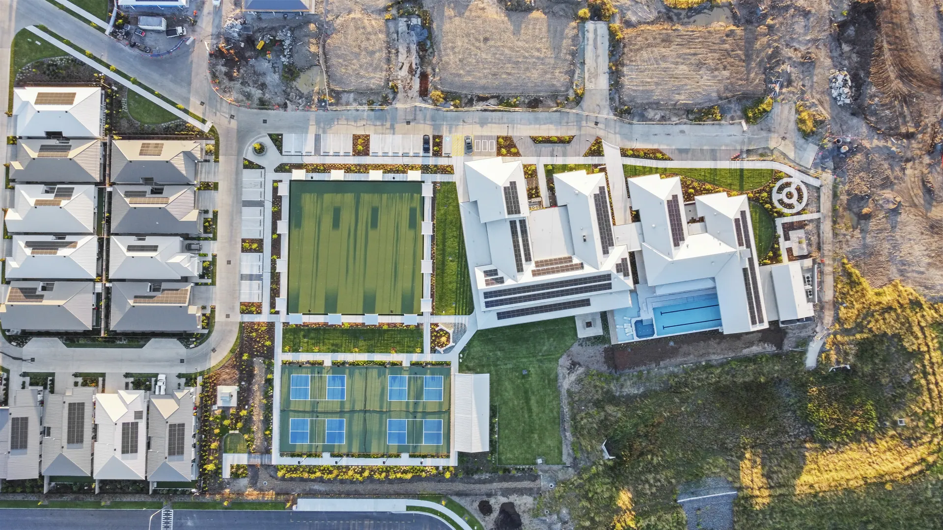 Aerial view of a seniors community clubhouse, bowls green and courts