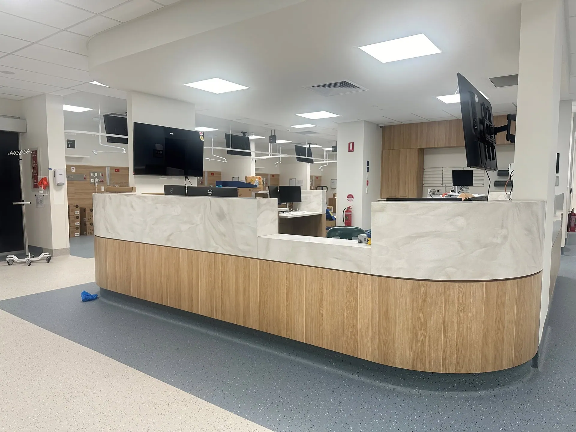 Healthcare reception and waiting area with curved timber and stone counter