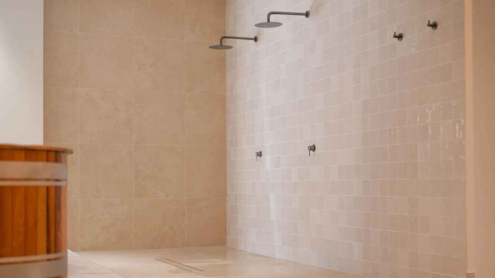 Communal shower area with handmade-look tiles